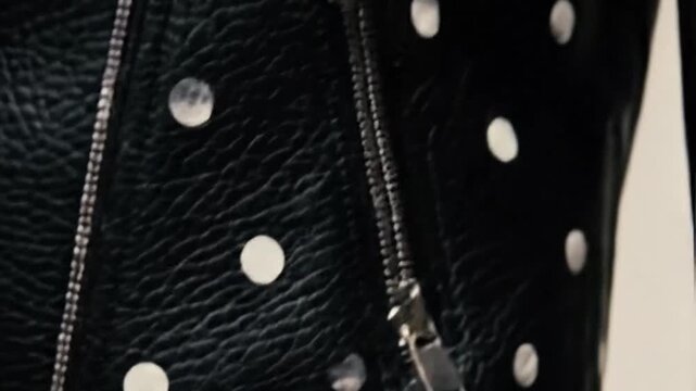 Shiny silver studs accentuate black jacket