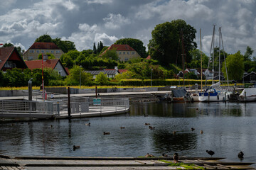 Waterfront view of Roskilde harbor captures Denmark’s serene coastal beauty.