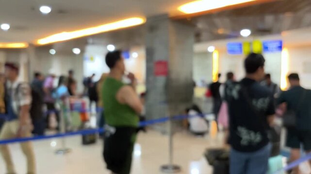 Passengers queue to board a plane at the airport terminal. Blur video.