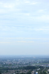 Panoramic City View with Lush Green Hills