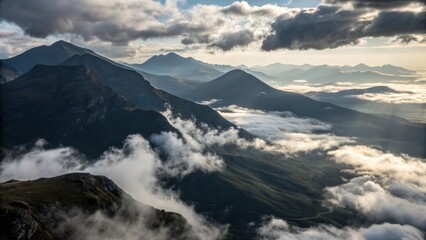 Breathtaking mountain range veiled in ethereal morning mist, bathed in dramatic golden sunbeams breaking through clouds