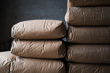 A pile of bags of cement stacked on top of each other