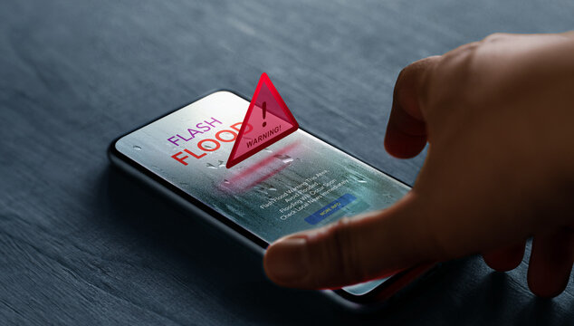 Smartphone shows flash flood alert, Climate change, Technology for safety - Powered by Adobe