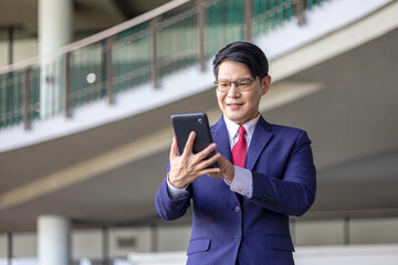 Fototapeta premium Young professional embraces digital business transformation, using tablet technology to drive innovation, next-generation solutions, and future-focused leadership in a modern workplace.