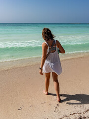 Woman Strolling on Beach in Solidaridad, Mexico