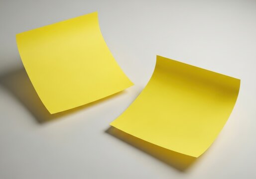 Two bright yellow sticky notes for reminders and planning on a plain surface