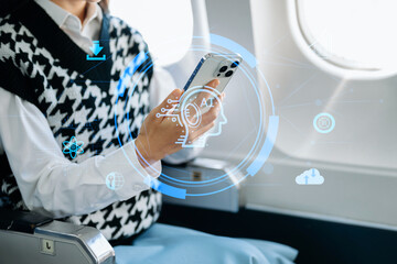 Asian businesswoman using tablet with AI digital interface during flight. Concept of artificial intelligence, innovation, and smart technology.