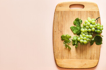 Green grapes on a wooden board, composition, space for text