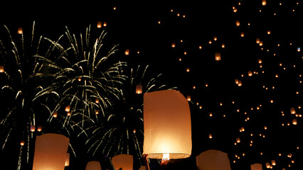 hundreds of paper lanterns glowing in the night sky during yi peng festival in chiang mai, thailand, as warm flames lift them gently, symbolizing wishes and letting go.