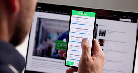 Man Signing Online Petition On Smartphone App
