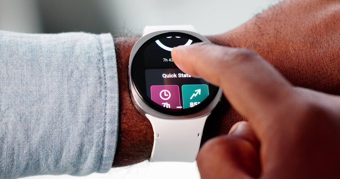 The African American Man Uses His Smartwatch Application To Monitor Sleep