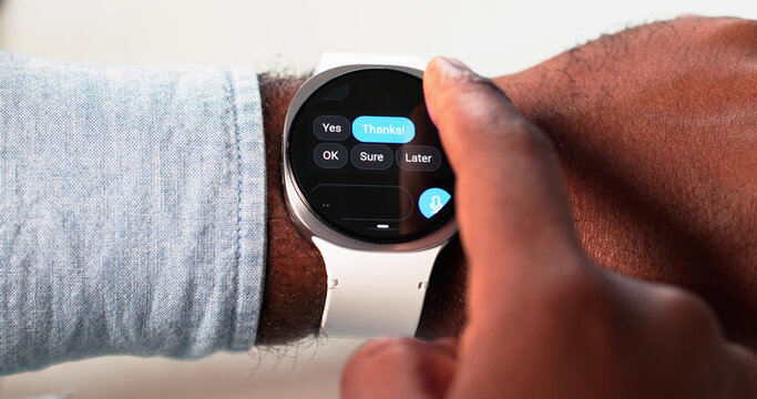 African-American Man Engaged In Messaging On Smartwatch