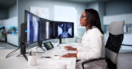 Radiologist Examining Knee X-ray For Surgery