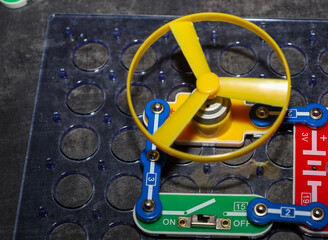 A fragment of an assembled electric circuit based on a construction kit, including a yellow...