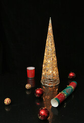 Christmas decorations on a black reflective surface