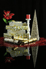 Decorative Christmas presents on black reflective surface