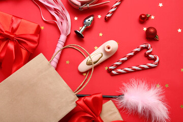 Obraz premium Shopping bag with sex toys and Christmas decor on red background