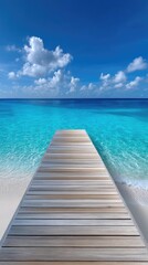 Wooden Pier Extending Into Crystal Clear Turquoise Ocean Under A Vibrant Blue Sky With Fluffy White Clouds On A Sunny Day