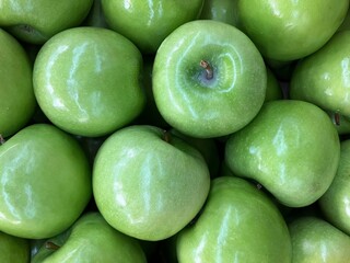 Full frame, background of shiny Granny Smith apples (fresh green apples).
