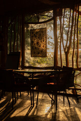 sunlight shining through decorative textile suzane carpet in uzbek wooden cafe interior