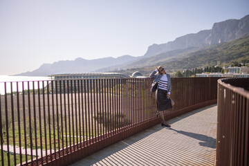 Woman mountains resort stylish traveler overlooking scenic coastal landscape