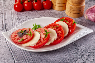 Italian caprese salad with mozzarella, tomato and basil
