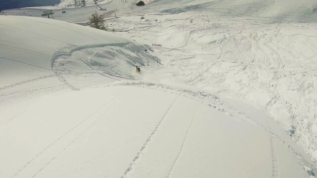 Slow motion footage of a snowboarder triggering a slab avalanche
