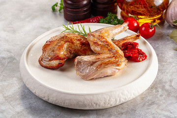 Roasted rabbit leg served rosemary