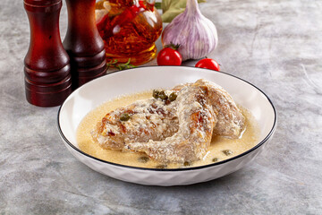 Roasted rabbit legs in cream sauce