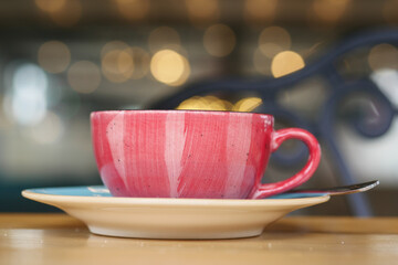 Colorful cup of coffee on a saucer at a cafe