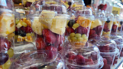 Fresh fruit cups displayed at a local market stall