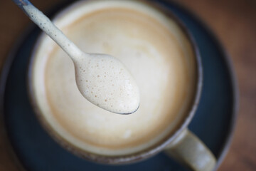 Creamy beverage served in a rustic cup at a cozy cafe