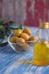 Fresh olives and olive oil on a rustic table display