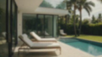 Fototapeta premium Blurry image of a swimming pool in a modern house, blending with nature with many trees surrounding the pool.
