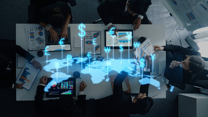 A diverse business team engages in collaboration over financial data, reviewing charts and currency symbols in a modern office, emphasizing teamwork and strategy. Trope