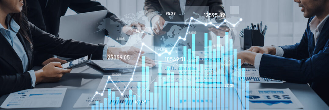 A diverse business team engages in a strategic meeting, using digital graphs and charts to analyze financial performance and drive growth in a modern office. Scalp