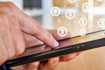 Person using smartphone with digital currency icons floating above