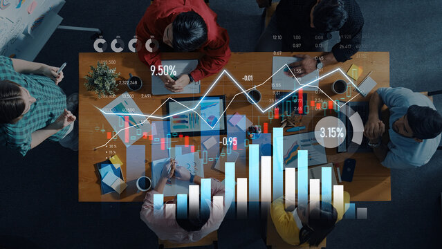 Aerial view of a diverse team engaged in data analysis using charts and graphs, showcasing collaboration in decision-making and strategic planning for business success. Scalp - Powered by Adobe