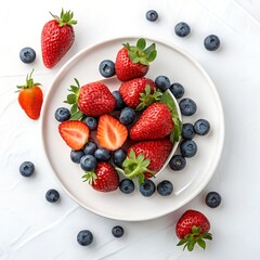 Fresh blueberries, strawberries, and raspberries on white plate, top view, natural light fruit photography