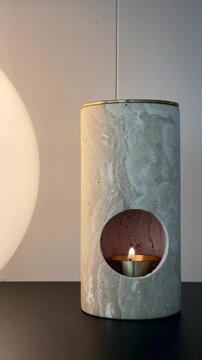 Lighting a candle in cozy home interior &ndash; relaxing warm light and calm evening atmosphere
