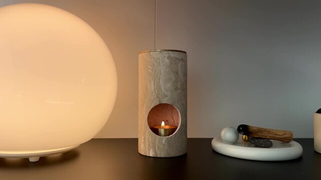 Lighting a candle in cozy home interior &ndash; relaxing warm light and calm evening atmosphere
