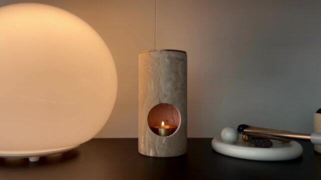 Lighting a candle in cozy home interior &ndash; relaxing warm light and calm evening atmosphere
