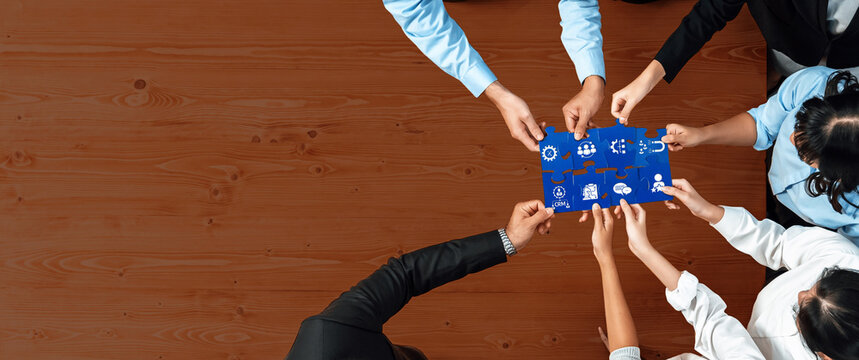 A diverse team engages in a collaborative business meeting, strategizing with ideas presented on blue paper in a modern office, illustrating effective teamwork and innovation. Amity