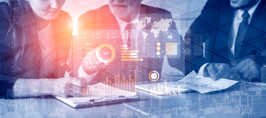 Business team engaged in a strategic discussion, analyzing vital data using digital tools, enhancing productivity and driving informed decisions in a modern corporate setting. Scalp