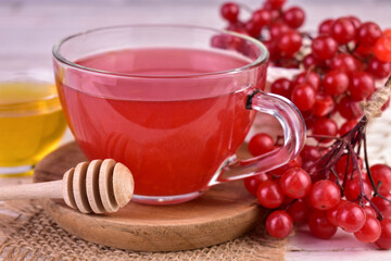 Viburnum berry tea in a transparent cup. Close-up. Medicinal tea for colds.
