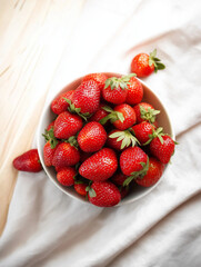 Bright Bowl Of Fresh Red Strawberries On White Linen Tabletop, Vibrant Summer Fruit Now Displayed