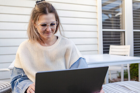 Mother working on her laptop in the garden