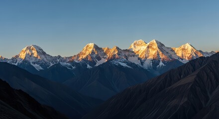 Majestic himalayan mountain range at sunrise with snow-capped peaks and golden glow