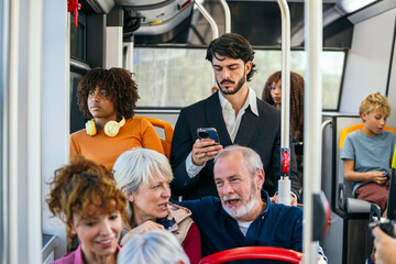 Diverse group of passengers traveling on a public city bus, representing different ages and backgrounds using various devices