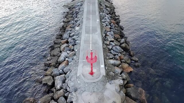 Scenic, real-time shot of colorful traditional fishing boats moored in the small, quaint port of Cand&aacute;s, Asturias, Spain. Historic coastal town architecture surrounds the harbor on a cloudy day